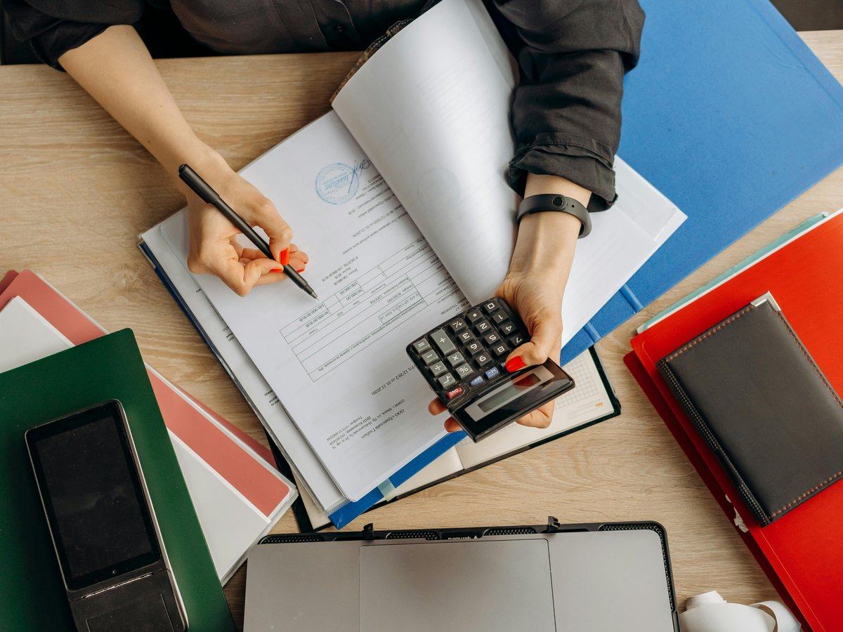 business-cases-for-transformation — page_hero background_image — pexels:calculator notebook pen desk financial analysis pr